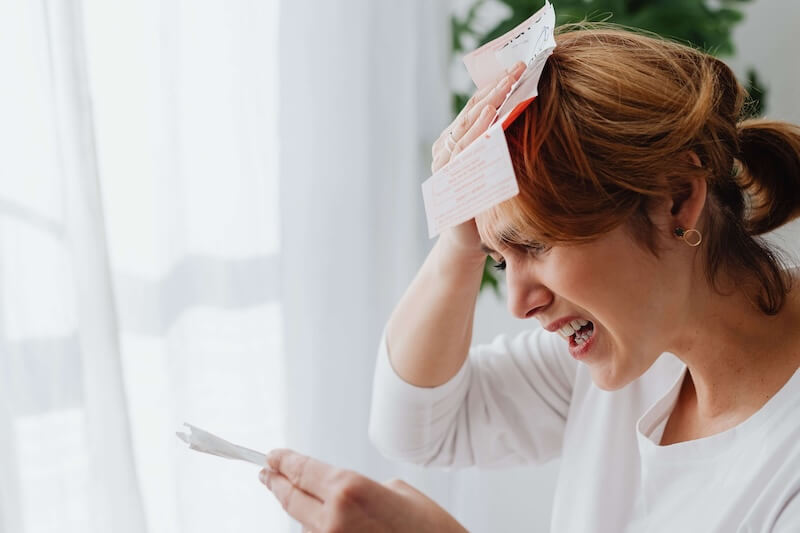 Care home manager looking stressed while holding shift paperwork and notes.